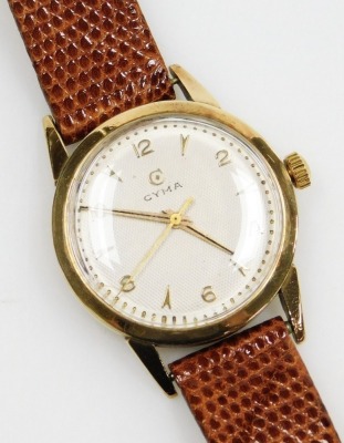 A Cyma 9ct gold gentleman's wristwatch, engine turned circular silver dial, bearing Arabic numerals, centre seconds, on a leather strap.