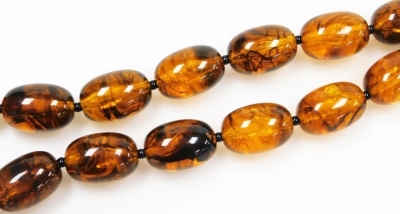 A string of graduated amber beads, with plated lobster claw clasp, forty beads, 114.5g all in. - 2