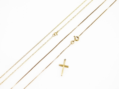 A 9ct gold cross pendant, together with two yellow metal neck chains, on 9ct gold bolt ring clasps, 2.6g all in.