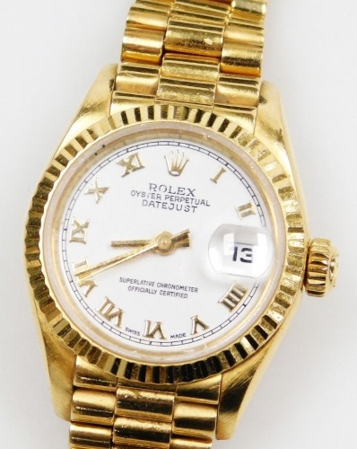 Withdrawn pre sale - A Rolex 18ct gold cased lady's wristwatch, oyster perpetual date just, superlative chronometer official certifies, circular white dial bearing Roman numerals, centre seconds, date aperture, serial number L359362, circa 1988, on an 18c