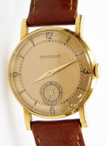 A Jaeger-Lecoultre gentleman's 9ct gold wristwatch, circular rose coloured dial bearing Arabic numerals at quarters, subsidiary seconds dial, cased back numbered 334979, on a leather strap.