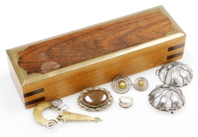 Silver and costume jewellery, including brooches, belt buckles and a silver ring, contained in a brass bound wooden box.