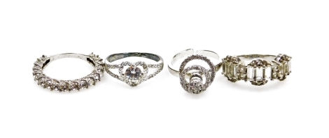 Four silver dress rings, each marked TGGC, each of stone set design comprising an eternity ring, halo ring, hoop ring, etc., all stone set, boxed. (4)