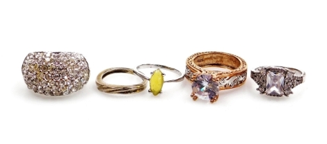 Five various dress rings, comprising an imitation diamond and amethyst set cluster ring, imitation opal ring, wedding band, gold finish solitaire, and a baguette cut ring, etc., all stamped 925, four boxes. (5)