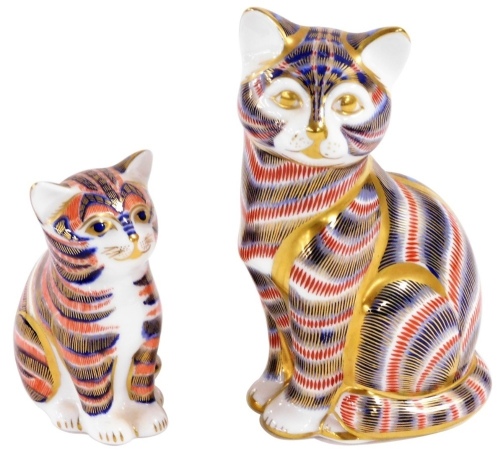 A Royal Crown Derby Imari porcelain paperweight, modelled as a seated cat, and another modelled as a kitten, gold stoppers, printed marks. (2)