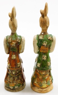 A pair of Chinese Tang style terracotta tomb figures, with brown, cream and green glazes, each holding a square parcel (AF), 38cm high. - 3