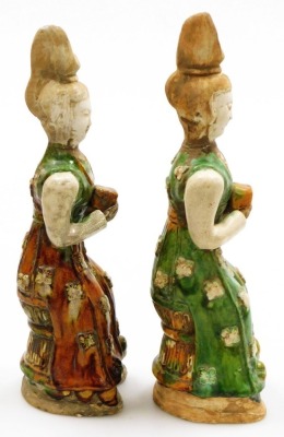 A pair of Chinese Tang style terracotta tomb figures, with brown, cream and green glazes, each holding a square parcel (AF), 38cm high. - 4