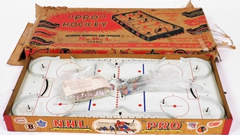 A 1950s Eagle tabletop pro hockey game, with original box, approximately 87cm wide.