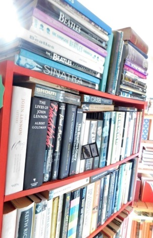 A collection of hardback and paper back books, each relating to music, to include books relating to The Beatles, Frank Sinatra, Bob Dylan, jazz, etc., lot to include red painted bookcase. This lot is situated in 14 East St, Horncastle, LN9 6AZ for Viewi