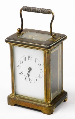 A 19thC brass cased carriage clock, enamel dial bearing Roman numerals, single barrel movement, in typical case, 11cm high, with carrying handle.