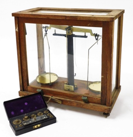 A set of Philip Harris Limited scientific laboratory scales, to weigh up to 250g, cased, 59.5cm wide, together with a set of weights, cased. (2)