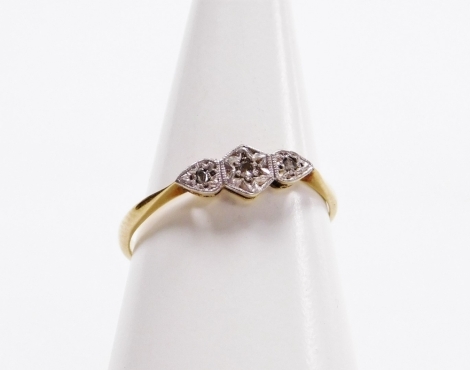 An 18ct gold and diamond three stone ring, illusion set, size P, 1.7g.