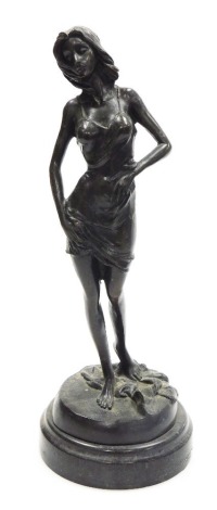 A bronze figure of lady, modelled standing, on a circular socle, signed F. Rude, 32cm high.