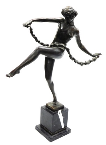 After Pierre Le Faguays (French 1882-1962). Bronze figure of a nude female dancer holding a rose garland, raised on a black marble base, 55cm high.