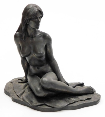 Roland Chadwick. A bronze finished resin figure of a naked lady, model seated on a sheet, 29.5cm wide.