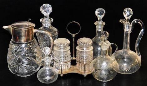 Victorian and later glassware, including cut glass decanters and stoppers, claret and oil jugs and stoppers, cut glass jug with plated mount, and a pair of cut glass jars and stoppers on a plated stand. (7)