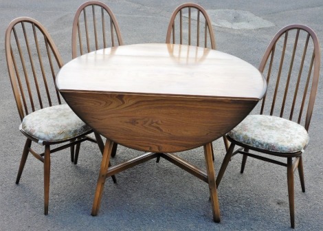 An Ercol elm drop leaf dining table, raised on square out swept legs united by an X framed stretcher, 71cm high, 112cm wide, 63.5cm deep, 124cm extended, and four chairs