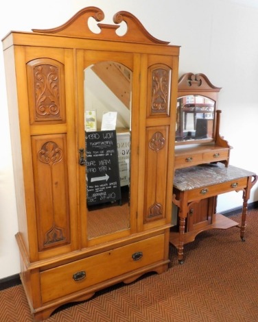 A Victorian satin walnut wardrobe, the break arch pediment above a single mirrored door, inset bevelled glass, flanked by carved foliate panels, opening to reveal hanging rail, over a single frieze drawer, raised on bracket feet, 201cm high, 114cm wide, 4