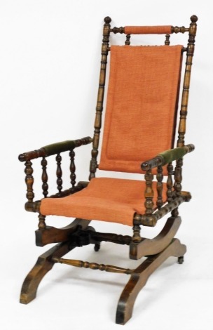 A late 19thC American beech rocking chair, with later upholstery.