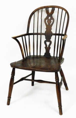 A Victorian ash and elm Windsor chair, with a vase shaped splat, solid saddle seat, raised on turned legs united by a H framed stretcher.