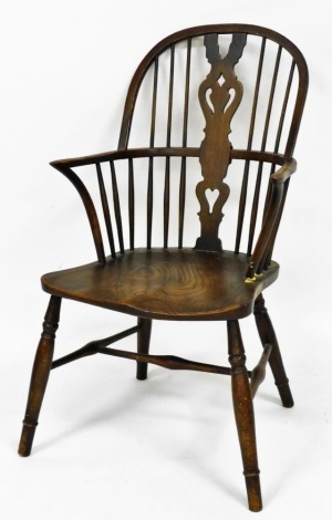 A Victorian beech and elm Windsor chair, with a shield shaped splat, solid saddle seat, raised on turned legs united by an H framed stretcher.