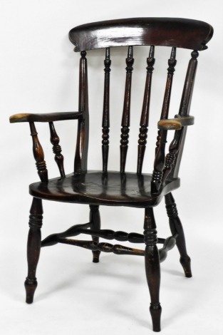 A Victorian stained ash and elm kitchen chair, with solid saddle seat, raised on turned legs united by a double H framed stretcher.