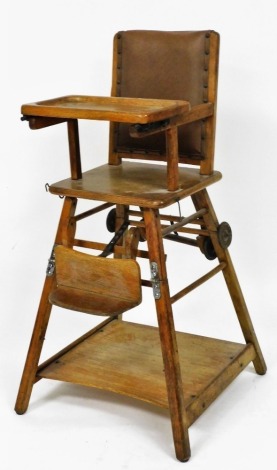 An early 20thC metamorphic oak child's chair, with leatherette back, 96cm high.