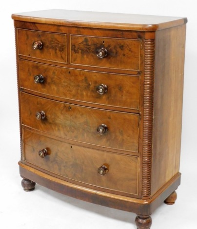 A Victorian flame mahogany bow fronted chest, of two short over three long drawers, raised on a plinth base and bun feet, 127cm high, 106.5cm wide, 54cm deep.