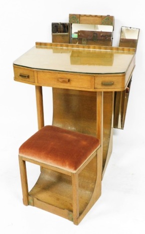 An Art Deco oak bow fronted dressing table, a triptych mirror over central frieze drawer flanked by two swivel side drawers, raised on canted square legs, with curved slope back and painted floral embellishments, 164cm high, 70cm wide, 45cm deep, together