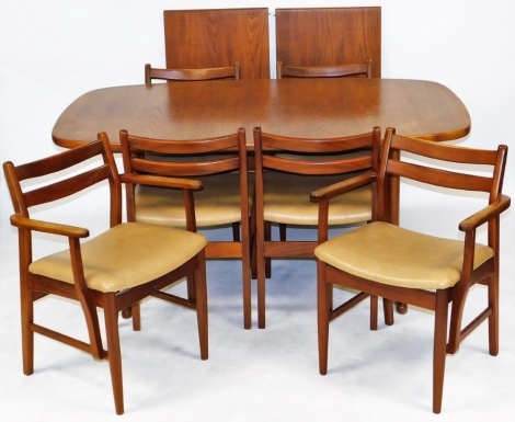 A 1960's teak dining table and chairs, possibly Meredew, the draw leaf table with two additional leaves, raised on T shaped ends, 72cm high, 162cm wide, 162cm extended, 100cm deep, together with six dining chairs, with cream leatherette seats, comprising 