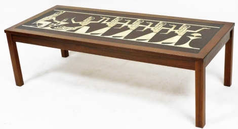 A mid century teak coffee table, possible Danish, with faux tile inset of stylised Egyptian pharaoh and attendants, raised on square legs, 40cm high, 129cm wide, 54cm deep.