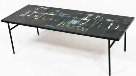 A mid century tile top coffee table, set with twenty four abstract black ground tiles, raised on brass capped black metal rod legs, 38cm high, 123cm wide, 46cm deep.