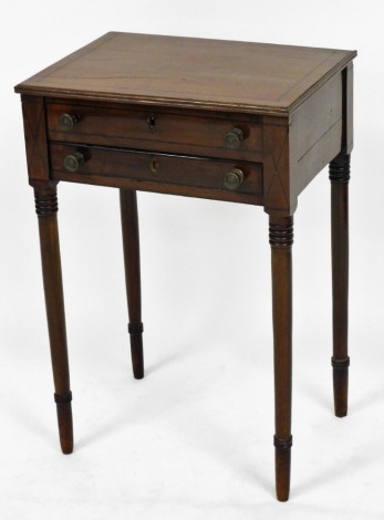 A George IV mahogany and ebony line inlaid side table, with hinged lid over a dummy drawer, and one further drawer, raised on ring turned legs, 69cm high, 46.5cm wide, 34.5cm deep.