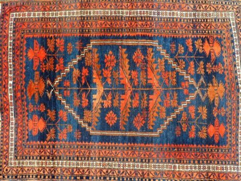 A Caucasian red ground rug, decorated with a central medallion containing floral motifs, within floral and repeating geometric borders, 154cm x 115cm.