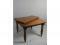 A Victorian oak extending dining table on turned legs with ceramic casters