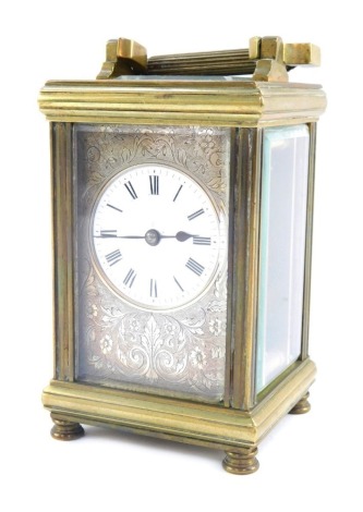 An early 20thC French brass carriage timepiece, with silvered floral scroll face, white enamel Roman numeric dial, mark to reverse Harrods, 12cm high.