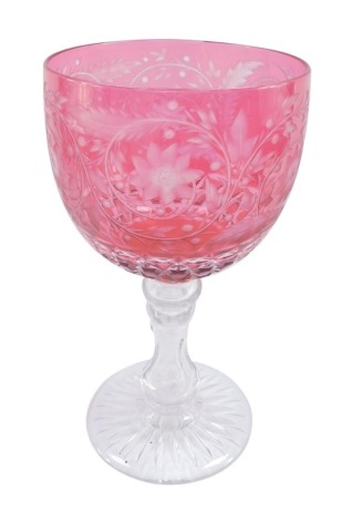 A Victorian cranberry glass goblet, the large shaped bowl with etched flower and vine decoration on a star set base, 32cm high.