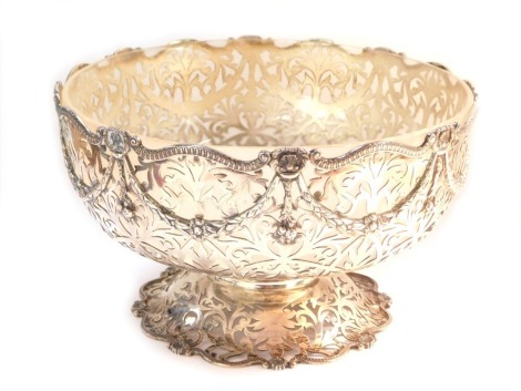 A George V Alex Clark & Co silver pierced bowl, with neo classical and shell caped swags on a pierced foot, Birmingham 1930, with frosted glass liner, 29oz, 14cm high.