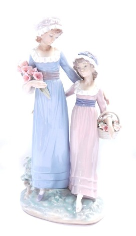 A Lladro porcelain figure group, mother and daughter picking flowers, 32cm high.