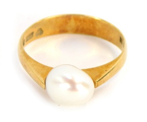 A pearl dress ring, with white lustre finish pearl in tension setting, on a yellow metal band, stamped 585, size L½, 3g all in.