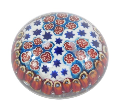 A Millefiori glass paperweight, with red, blue and white cane detail, 9cm diameter.