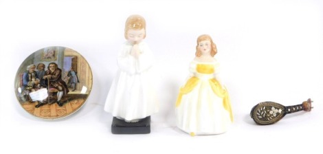 A group of ceramics, comprising a Royal Doulton Bedtime figure HN1978, 14cm high, Royal Doulton Penny HN2424, 12cm high, a Prattware pot lid Dr Johnson, 10.5cm diameter, and a tortoise shell mother of pearl inlaid miniature mandolin, 10cm high. (4)