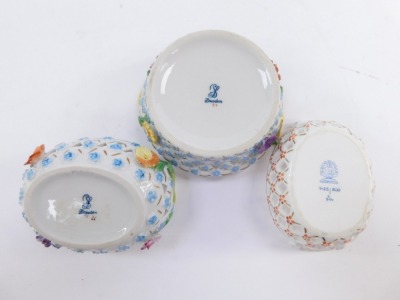 Three 20thC continental porcelain baskets, comprising a Herend of Hungary orange flower detailed pierced basket, with blue stamp to underside, 8cm diameter, a circular basket with pierced design, hand painted floral motif to centre and gilt borders, marke - 3