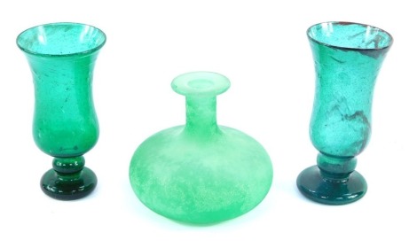 A group of green glassware, comprising a green bottle vase, 11cm high, and two similar design green blown glass goblets, 15cm and 14cm high. (3)