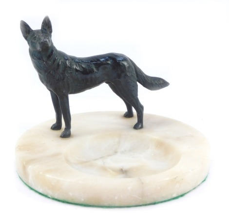 A French alabaster dish, circular with applied bronzed spelter figure of a dog, 16cm diameter.