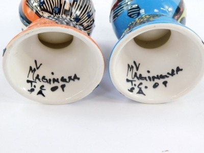 A pair of Magineya continental porcelain egg cups, modern art design with bold painted borders, with leaves, spots and animals, sign to interior, 8cm high. - 2