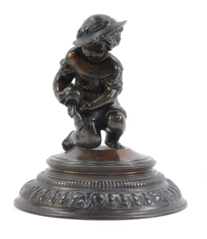 A late 20thC spelter figure of a seated child, pouring water on a bronzed finished stepped foot, 14cm high.