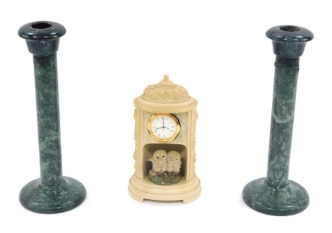 A group of ceramics, comprising a pair of green marble candlesticks, 20cm high, and a Country Artist white finish mantle clock, with owl figure group, 15cm high. (3)