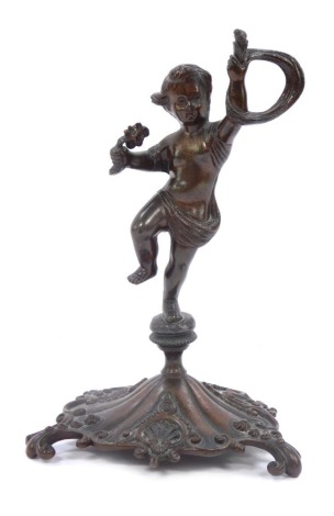 A bronze figure of a child with rope, on a rococo tripod base, 18cm high.
