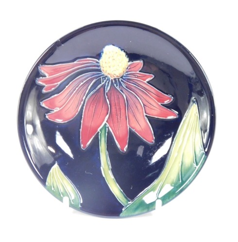 A Moorcroft pin dish, with red peony, trial piece dated 3.1.03, with mushroom stamp, 12cm diameter.